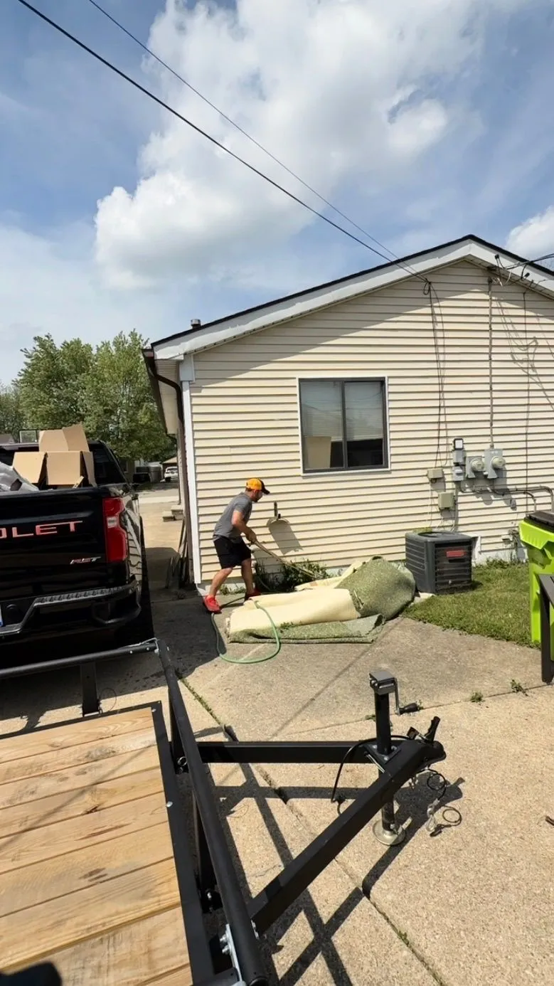 Old carpet and padding pulled up and staged for removal in Roseville, Michigan