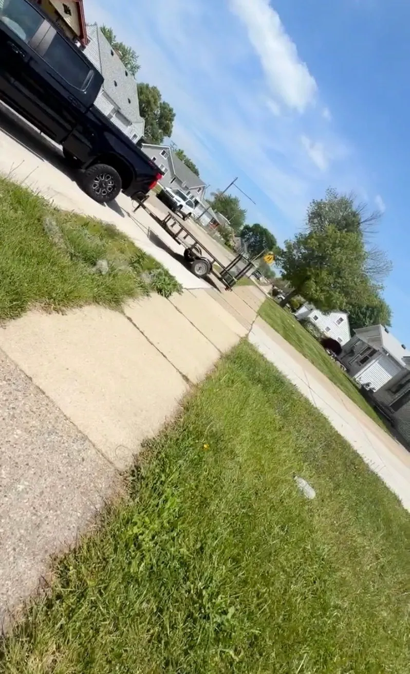 Demohaulic truck and trailer on site for a junk removal job in Roseville, Michigan