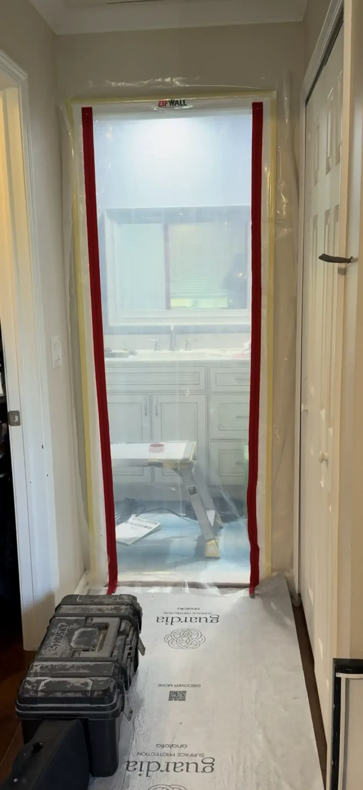 Zipper wall dust containment installed outside an upstairs bathroom demolition area in Farmington Hills Michigan