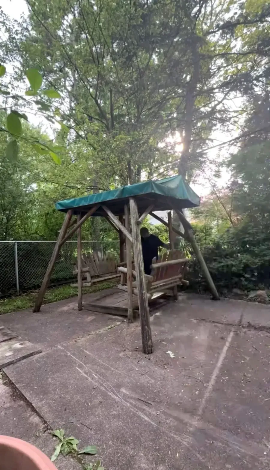 Covered wooden swing structure before demolition in Grosse Pointe Woods Michigan
